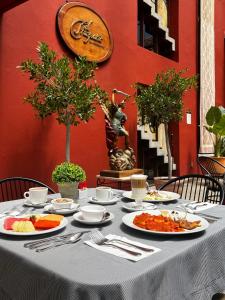 圣克里斯托瓦尔-德拉斯卡萨斯Posada Real de Chiapas的一张桌子,上面放着食物盘