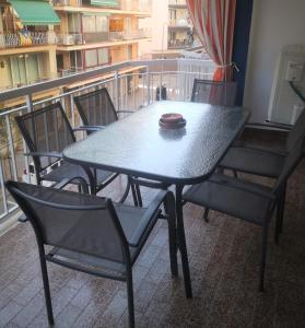 皮内达德马尔Apartament LA SAL的阳台顶部的桌椅和碗