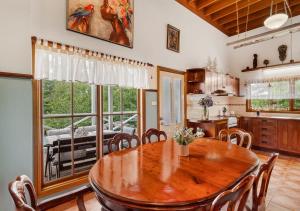 肯图巴Blue Country Lodge的厨房以及带木桌和椅子的用餐室。