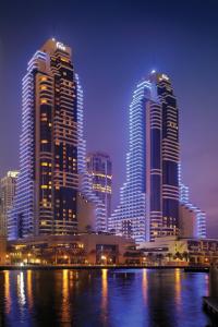 迪拜Grosvenor House, a Luxury Collection Hotel, Dubai的一群高大的建筑在晚上在城市里