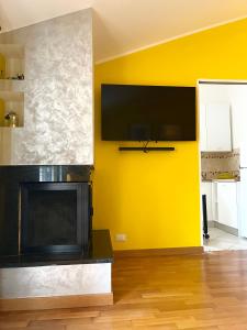 特拉莫Yellow House的客厅设有壁炉和黄色墙壁