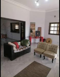 洛美Villa Stella的客厅配有沙发和椅子