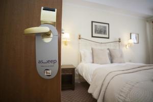 什鲁斯伯里The Lion Hotel Shrewsbury的酒店客房的门上设有一张床和一个标志
