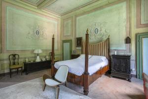 卢卡Villa Sardi Small Luxury boutique Hotel的一间卧室配有一张床和一把椅子