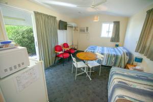 MitchellMitchell Motel & Cabin Park的配有一张床和一张桌子及椅子的房间