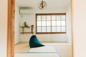 IeuraTokuto"Queen Villa" - Vacation STAY 81603v的蓝色枕头坐在带窗户的房间里