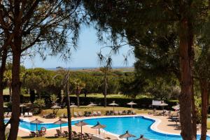 厄尔-汝姆披多朗皮多精品度假酒店的享有带遮阳伞和椅子的游泳池的景色