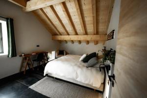 普雷芒翁La Loge de la Dolarde - Chambre Nord-Est的一间卧室设有一张床和木制天花板
