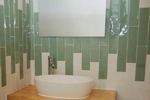 圣尼科拉斯德尔普埃尔托巴坦德拉斯蒙哈斯公寓酒店的浴室设有白色水槽和镜子