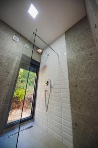 波德戈里察KOKO VILLAGE的带淋浴的浴室和玻璃门