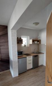 巴什卡沃达Apartman Saric K&M的厨房配有水槽和炉灶 顶部烤箱