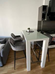EbenthalWunderschöne, neue Wohnung mit großer Terrasse的带沙发的客房内的白色桌椅