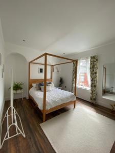 格兰瑟姆Luxury Spacious Renovated Townhouse的一间卧室,卧室内配有一张天蓬床