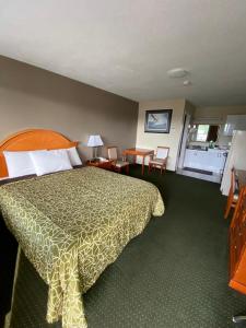 Angus安格斯汽车旅馆的酒店客房带一张床、一张桌子和椅子