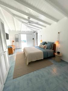 Saint BarthelemyLe Bungalow & Car rental的白色卧室设有床铺和白色天花板