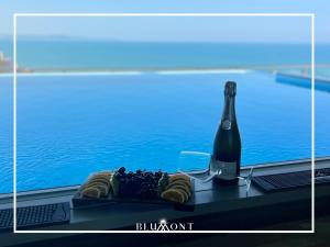 都拉斯Luxury Rooftop Suites by Blumont的一瓶香槟、一盘水果和一瓶葡萄酒