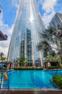 深圳深圳盐田凯悦酒店的一座高大的建筑,前面有一个游泳池