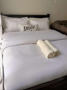 内罗毕Blue Falls Queen Studio的一张白色的大床,带两条毛巾