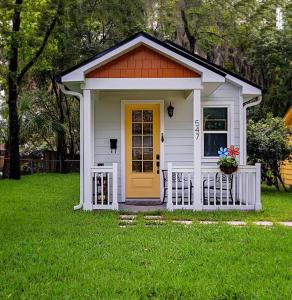 奥兰多Downtown Tiny Life - Experience Tiny Living!的院子中一扇黄色门的小房子