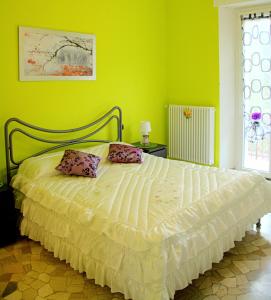 VillagrandeB&B Il Poggio的绿色卧室配有带两个枕头的床