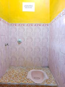 外南梦SPOT ON 92857 Kos Haji Jakfar Syariah的浴室设有粉红色的卫生间和黄色的墙壁