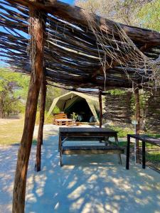DivunduKuvira River Camp的帐篷前设有野餐桌