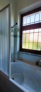 AndrateCasa in montagna con giardino privato recintato的带浴缸的浴室和窗户。