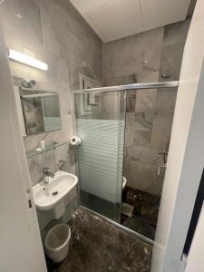 科威特Gulf grand hotelجلف جراند اوتيل的一间带玻璃淋浴和水槽的浴室