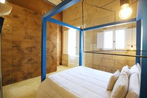 马尔塔诺Don Agostino Relais Masseria的一间卧室配有一张蓝色框的床