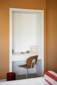 戛纳艾博利亚酒店的配有一张桌子和一张椅子的床边的房间