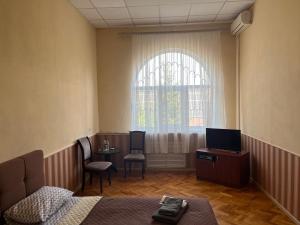 第聂伯罗Barvy Dnipra的客房设有床、桌子和窗户。