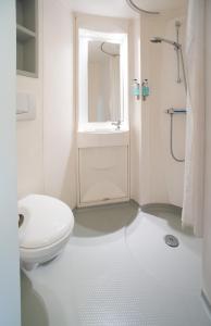 卢顿CiTi Hotel London Luton的白色的浴室设有卫生间和水槽。