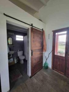 默西迪丝Casa de campo的一间带卫生间和木门的浴室