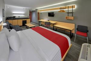 墨西卡利墨西卡利都市快捷酒店的酒店客房设有一张大床和一个厨房。