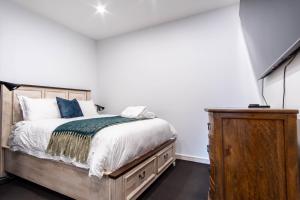 悉尼Eggies Nest - Sydney City Apartment的一间卧室配有一张床和一个木制梳妆台