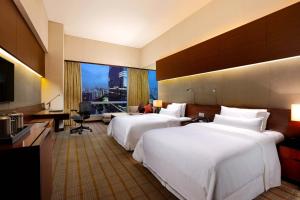 广州广州海航威斯汀酒店的酒店客房配有两张床和一张书桌