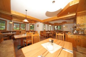 斯拉德明赫尔曼咖啡厅酒店的餐厅设有木桌和木椅