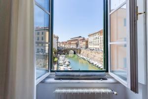 利沃诺Livorno-Mercato delle Vettovaglie Central Apt!的享有河流和桥梁景致的窗户
