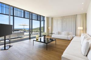 博德鲁姆Barbaros Reserve Bodrum Residences Managed by Kempinski的客厅配有白色的沙发和桌子