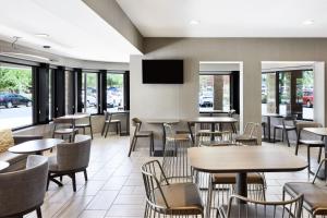 坦培凤凰城天普机场春季山丘套房酒店的餐厅设有桌椅和平面电视。