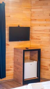 KumlucaAraz Wooden Concept的木墙上配有电视的房间