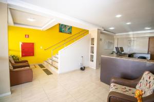 Sobradinho阿尔维马尔酒店的大堂设有黄色的墙壁和楼梯