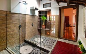 怡保快乐窝遗产住宿旅馆的浴室里装有盆栽植物的玻璃淋浴间