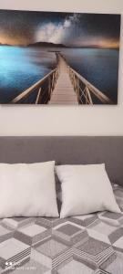 索伦托Il Tulipano的一张带两个枕头的床和一幅桥画