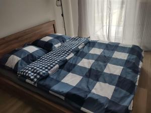 波兹南STARA CEGIELNIA, Faktura VAT, bezkontaktowe zameldowanie的一张带蓝白毯子的床