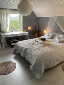 弗洛兰德维尔克Hytte Sørlandet med spa的一间卧室设有一张大床和一个窗户。