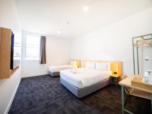 悉尼YHA Sydney Harbour的配有一张床和一张书桌的酒店客房