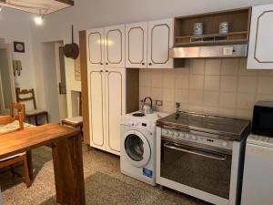 彼得拉桑塔Casa Pucci的厨房配有炉灶和洗衣机。