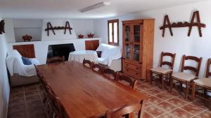 卡斯特里尔Cortijos Rurales Castril, El Casto的一间带木桌和椅子的用餐室