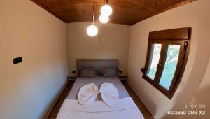 萨莫色雷斯Villa Potamia的小房间,床上有一个弓